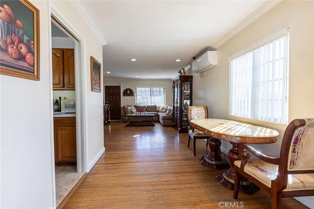 a dining room with furniture and wooden floor