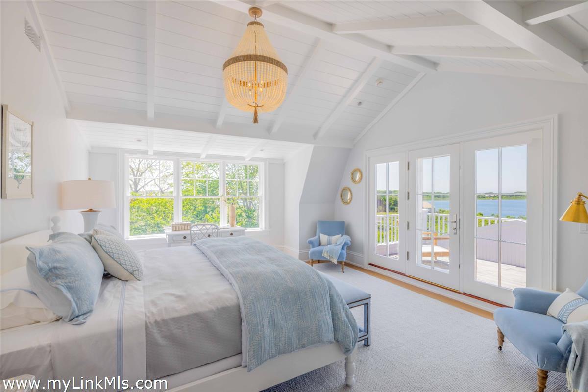 256 Polpis Road Nantucket, MA 02554 - Photo 20 of 30 a bedroom with a bed and a large window