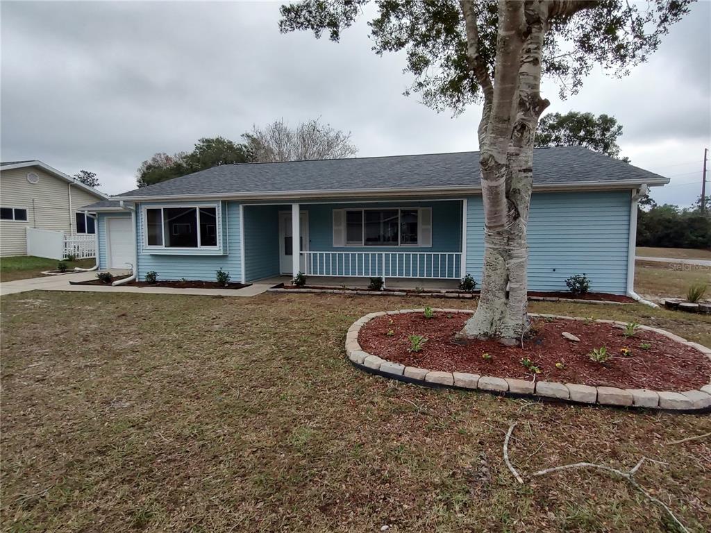 8792 Southwest 116th Place Road Ocala, FL 34481 - Photo 1 of 6 a front view of a house with entertaining space