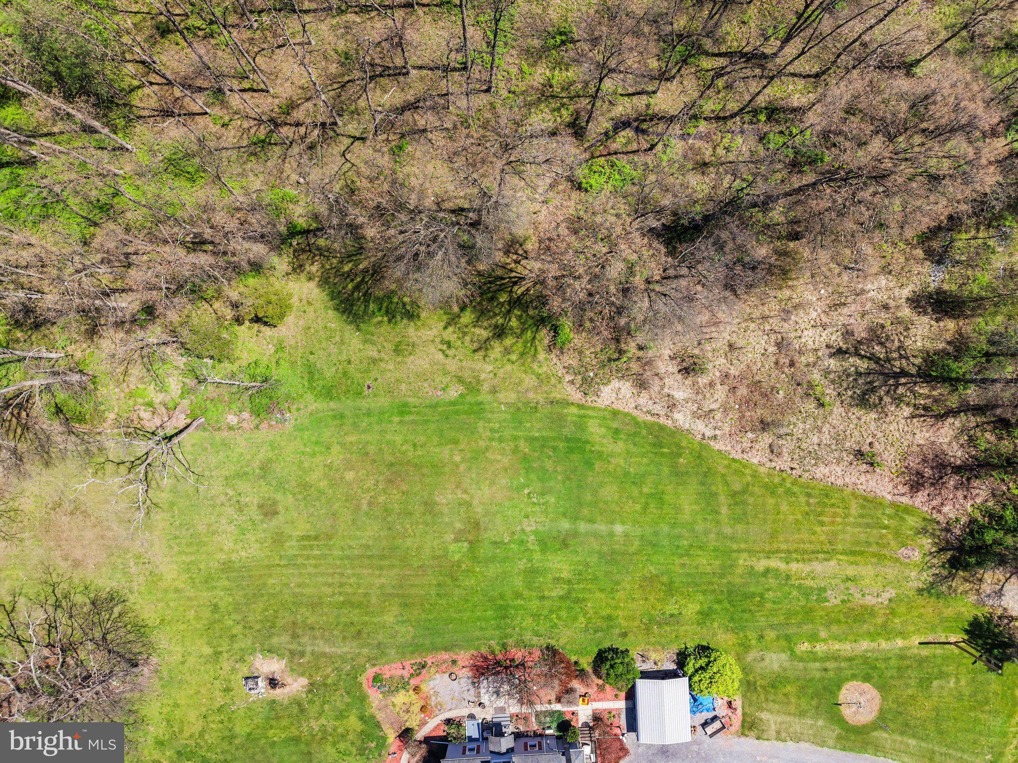 0 Cedar Grove Road Mifflintown, PA 17059 - Photo 7 of 9 a backyard of a building with large trees and plants