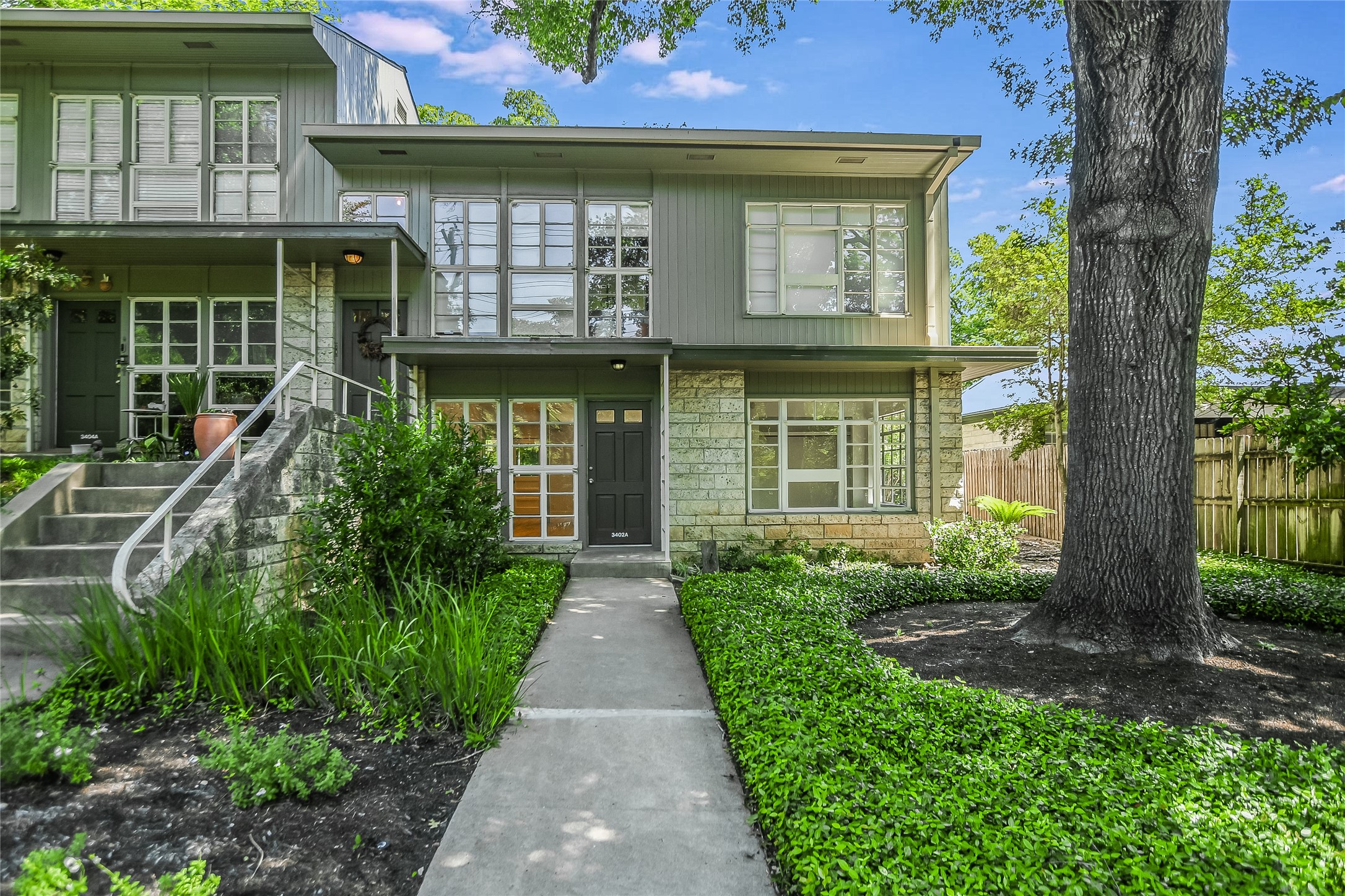 3402 Enfield Road, Unit A Austin, TX 78703 - Photo 1 of 1 a front view of a house with a garden
