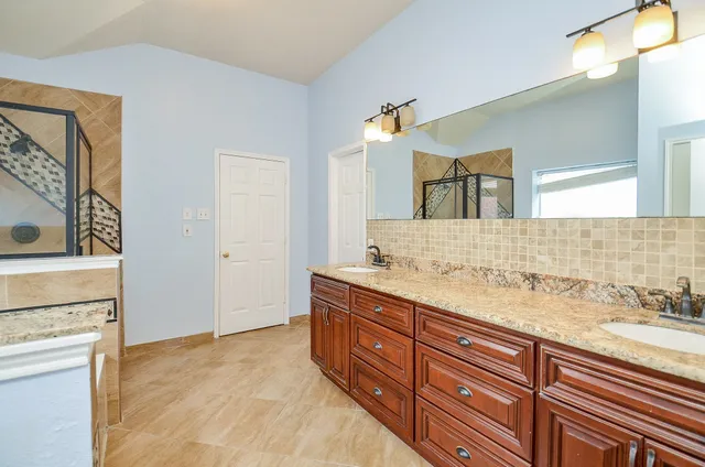a bathroom with a bathtub and a shower