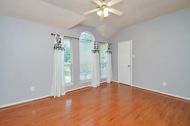 a bathroom with a granite countertop sink a mirror and a shower