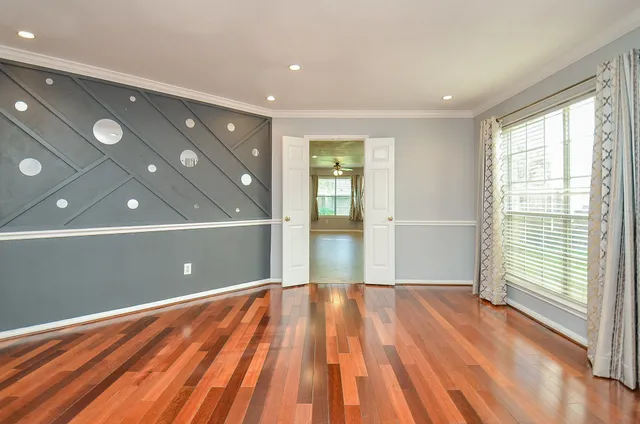 a view of entryway and hall with wooden floor