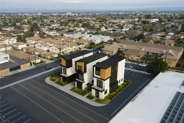 an aerial view of residential houses with outdoor space