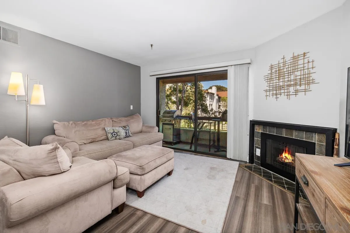 5605 Friars Road, Unit 308 San Diego, CA 92110 - Photo 11 of 39 a living room with furniture and a fireplace