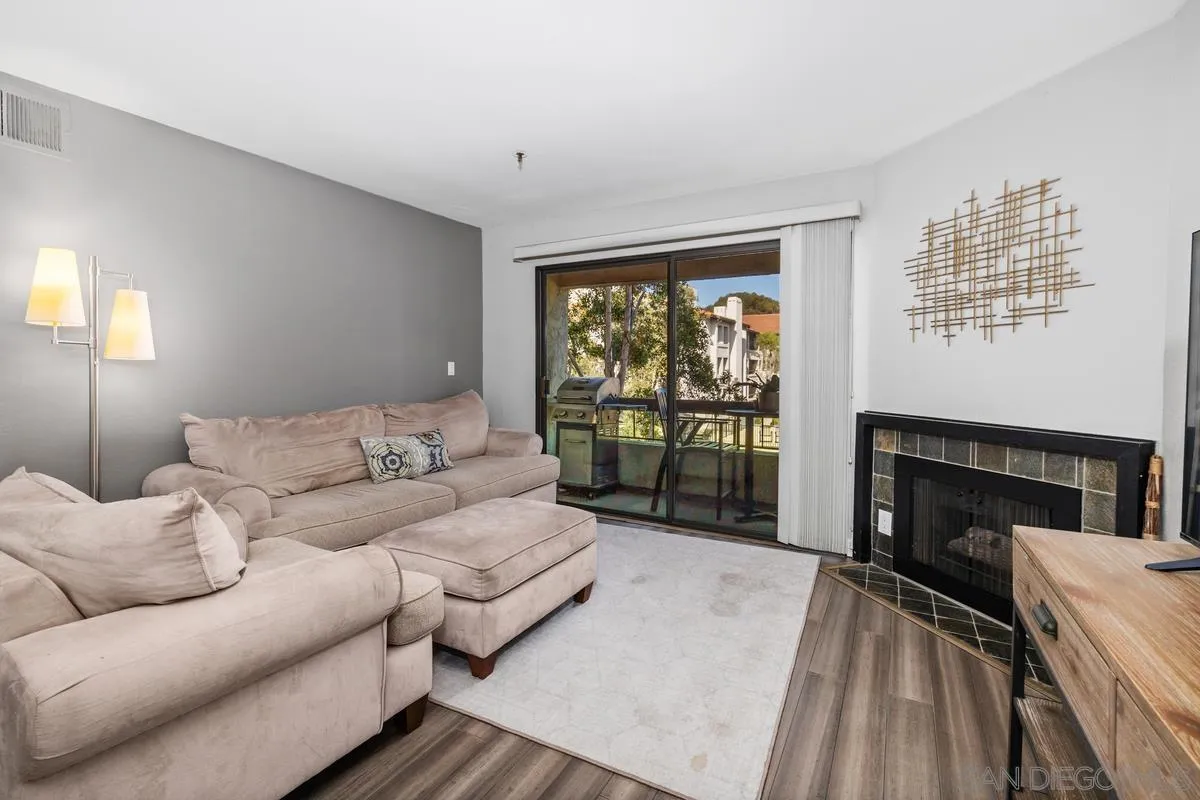 5605 Friars Road, Unit 308 San Diego, CA 92110 - Photo 12 of 39 a living room with furniture and a fireplace