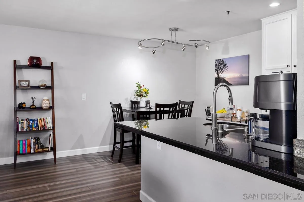 5605 Friars Road, Unit 308 San Diego, CA 92110 - Photo 13 of 39 a kitchen with stainless steel appliances granite countertop a sink dishwasher and a stove with wooden floor