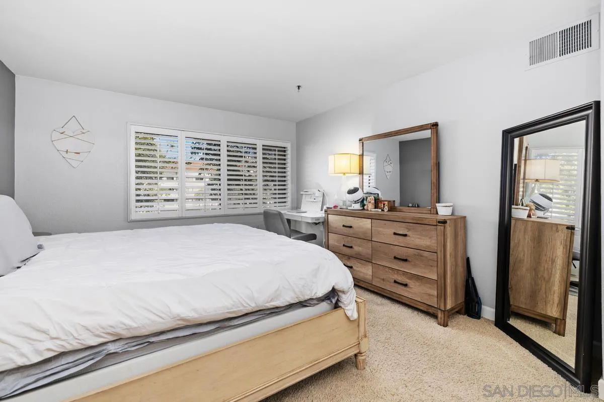 5605 Friars Road, Unit 308 San Diego, CA 92110 - Photo 15 of 39 a bedroom with a bed and a dresser