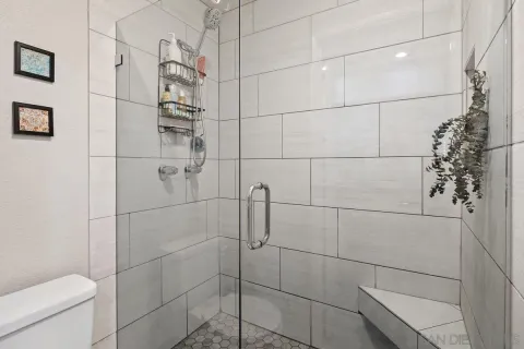 a bathroom with a toilet and shower