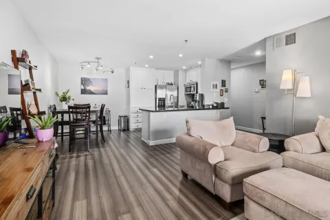 a living room with furniture and wooden floor
