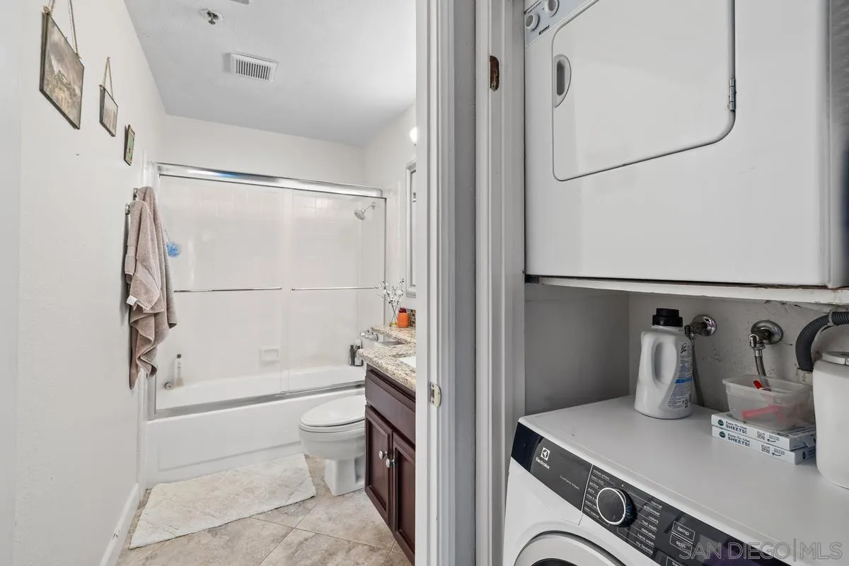 5605 Friars Road, Unit 308 San Diego, CA 92110 - Photo 22 of 39 a bathroom with a sink a toilet and shower