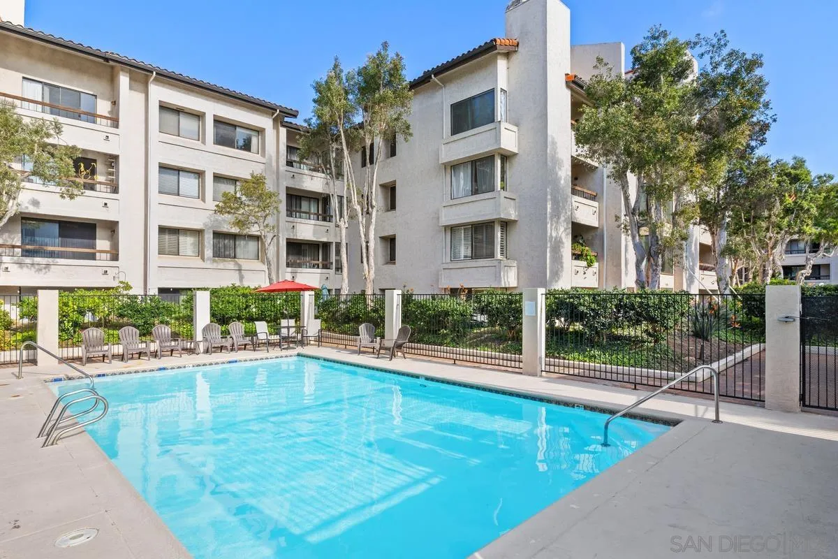 5605 Friars Road, Unit 308 San Diego, CA 92110 - Photo 27 of 39 a view of a swimming pool with a lounge chairs