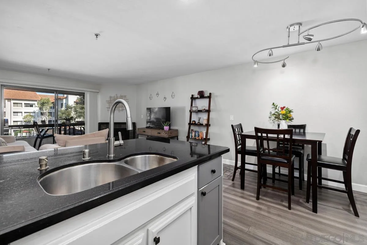 5605 Friars Road, Unit 308 San Diego, CA 92110 - Photo 7 of 39 a kitchen with a dining table and chairs