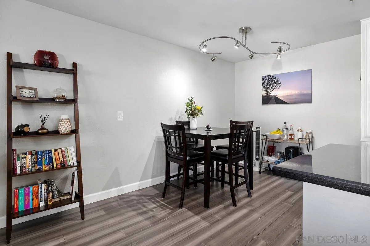 5605 Friars Road, Unit 308 San Diego, CA 92110 - Photo 8 of 39 a view of a dining room with furniture and wooden floor