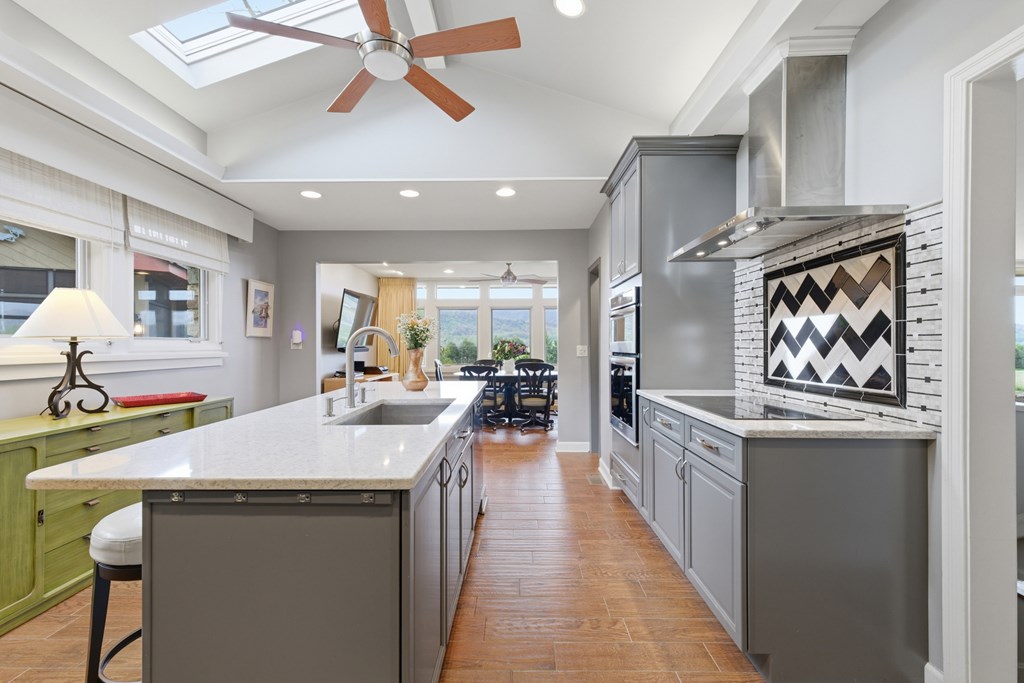 6203 Airport Road Andrews, NC 28901 - Photo 10 of 50 a large kitchen with stainless steel appliances a stove center island a table and chairs