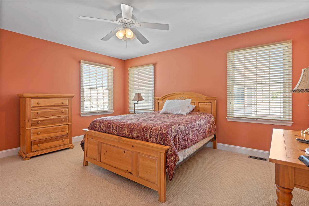 5441 Ocean Drive Avalon, NJ 08202 - Photo 18 of 26 a bedroom with a bed dresser and a window