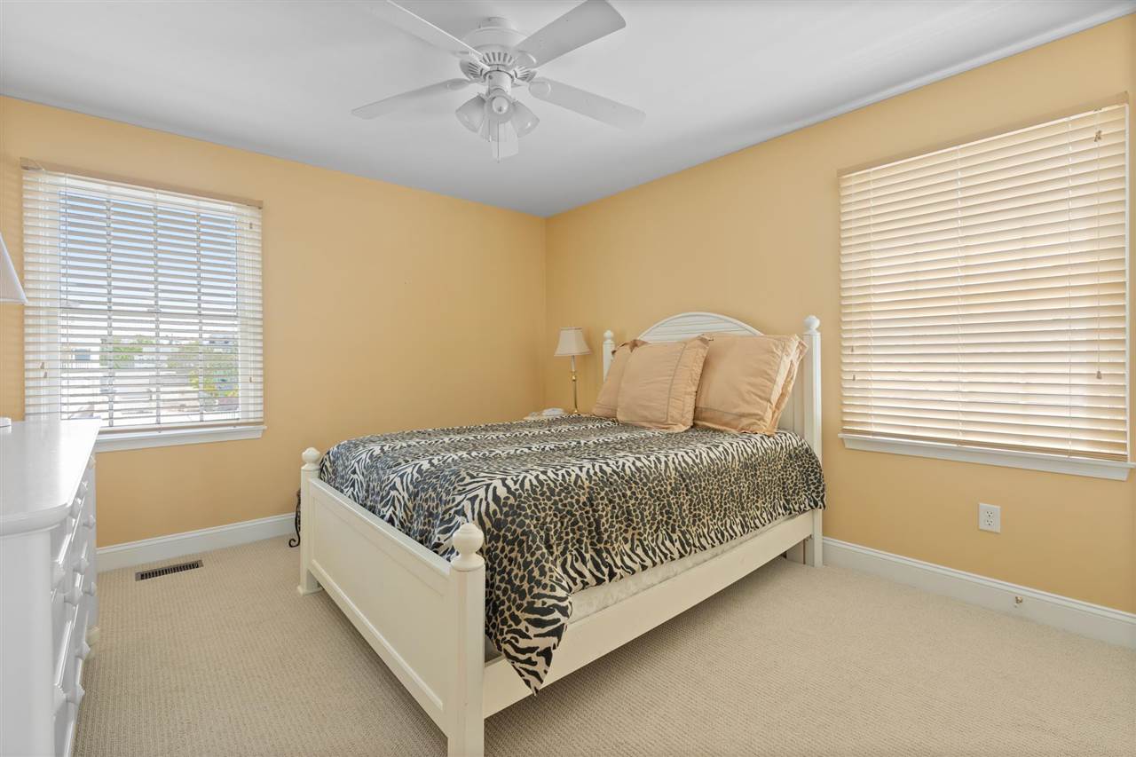 5441 Ocean Drive Avalon, NJ 08202 - Photo 19 of 26 a spacious bedroom with a bed and window