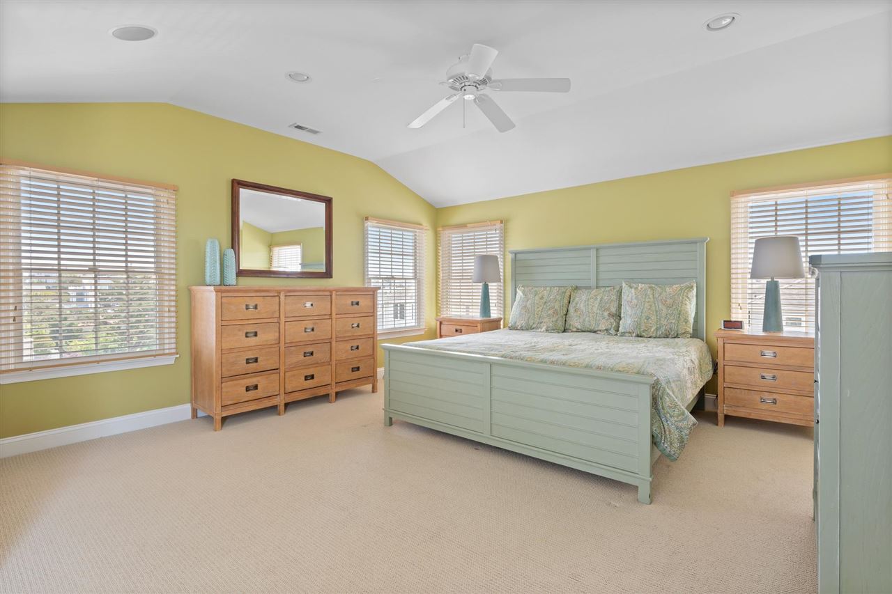 5441 Ocean Drive Avalon, NJ 08202 - Photo 20 of 26 a bedroom with a bed and a chandelier