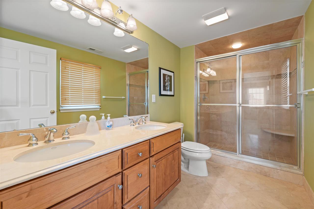 5441 Ocean Drive Avalon, NJ 08202 - Photo 22 of 26 a bathroom with a sink mirror vanity and toilet