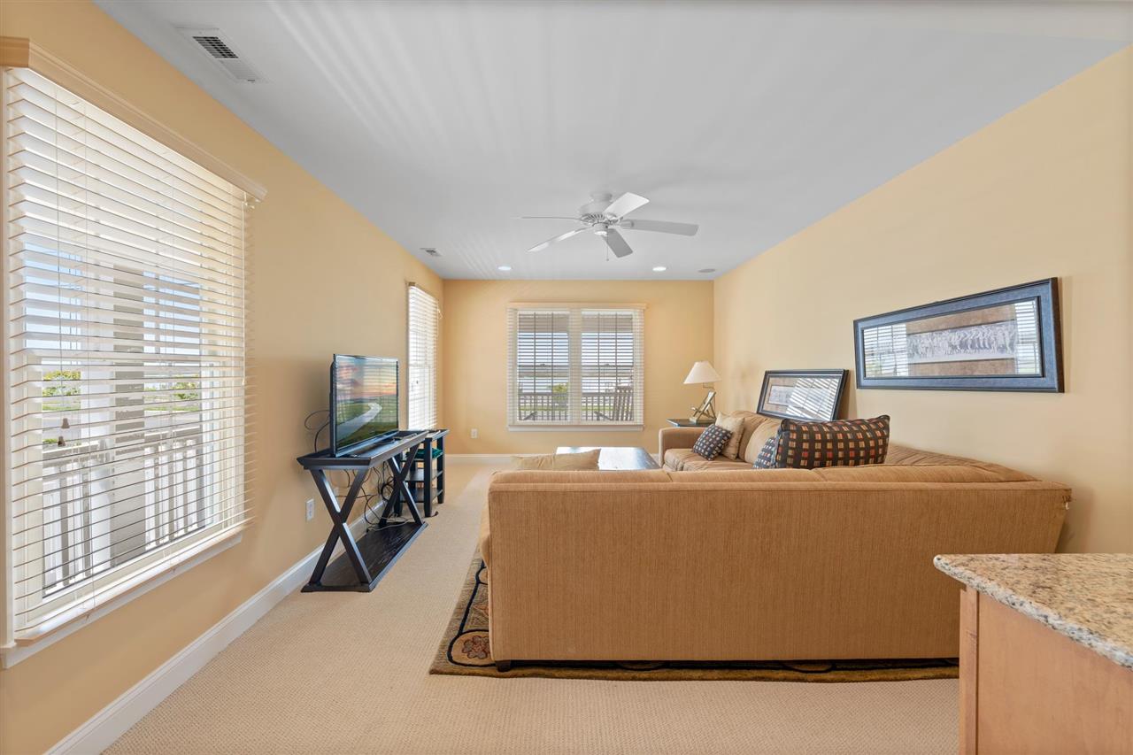 5441 Ocean Drive Avalon, NJ 08202 - Photo 4 of 26 a living room with furniture a flat screen tv and a large window