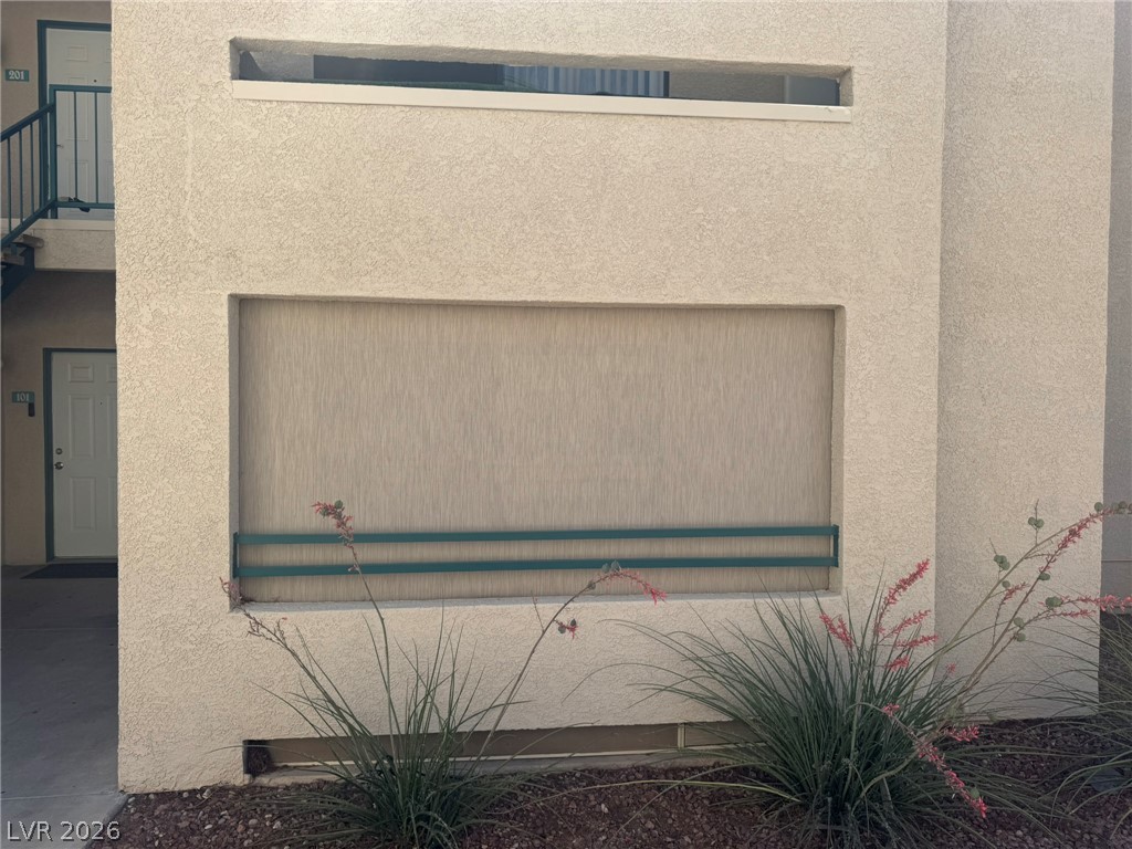 5141 South Lindell Road, Unit 102 Las Vegas, NV 89118 - Photo 2 of 17 The building's exterior features a stucco finish and small, low-maintenance landscaping.