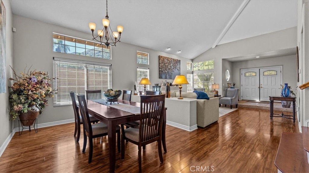 1671 Dominguez Ranch Road Corona, CA 92878 - Photo 12 of 42 The formal dining area features elegant lighting, large windows, and an open layout, providing a perfect setting for entertaining and special occasions.
