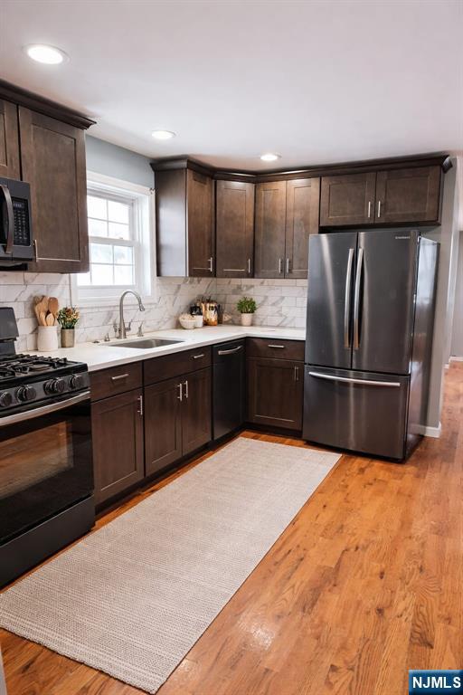21 Rose Street Paterson, NJ 07501 - Photo 3 of 4 a kitchen with stainless steel appliances a stove a sink and a refrigerator
