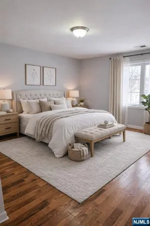a bedroom with a large bed and a large window