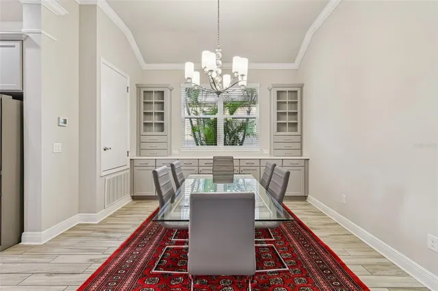 a view of a dining room with furniture a rug and wooden floor