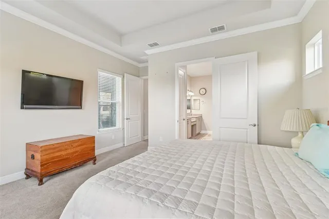 a bedroom with a bed and a flat screen television