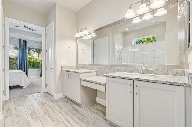 a bathroom with a sink vanity granite and a mirror