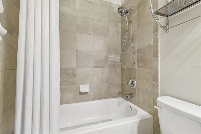 a bathroom with a bathtub and a toilet