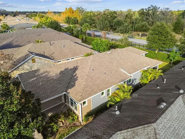 an aerial view of a house with a yard