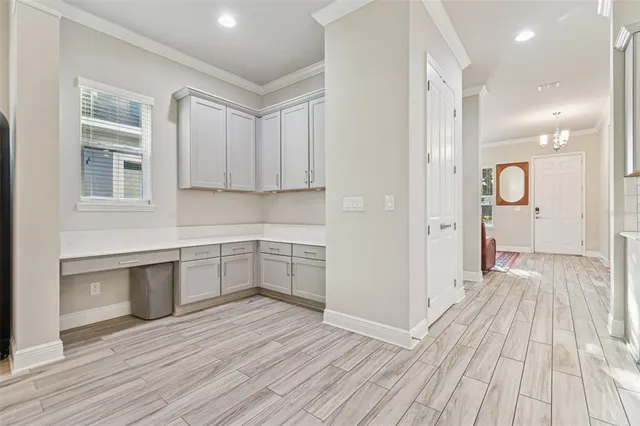 a view of a kitchen with wooden floor and a sink