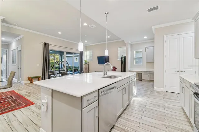 a large kitchen with kitchen island a sink stainless steel appliances and cabinets