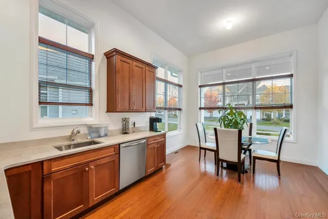a kitchen with a table chairs and wooden floor