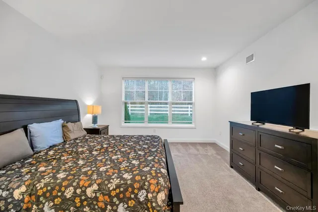 a bedroom with a bed and a flat screen television