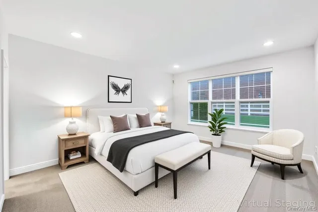 a spacious bedroom with a bed and a large window