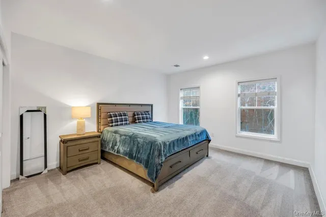 a spacious bedroom with a bed and a window