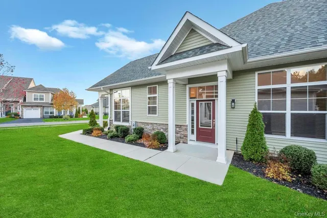 a view of a house with backyard and porch