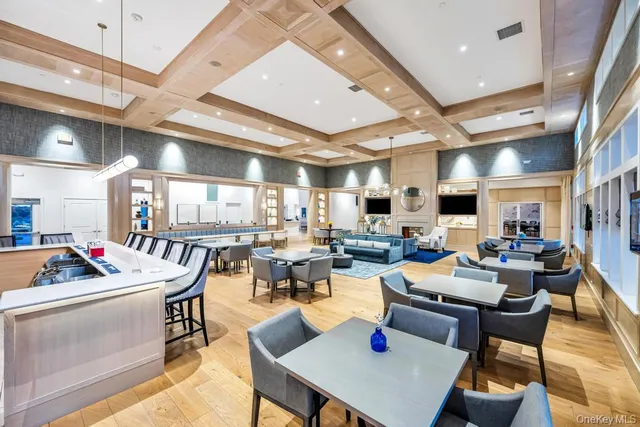 a living room with lots of furniture and kitchen view