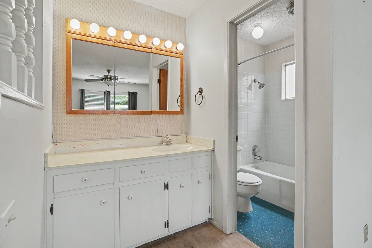 1811 Terry Lane Georgetown, TX 78628 - Photo 21 of 40 A well-lit bathroom features a vanity with ample storage and a full tub/shower combination.