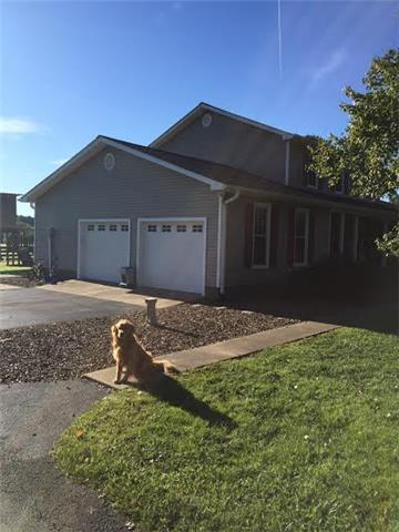 398 Patrick Road Fayetteville, TN 37334 - Photo 2 of 13 Side view of 398 Patrick Road. Paved driveway with two- car garage and walk way to the front porch!