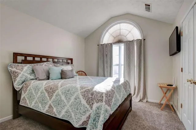 a bedroom with a bed and window