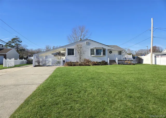 a front view of a house with a garden and yard