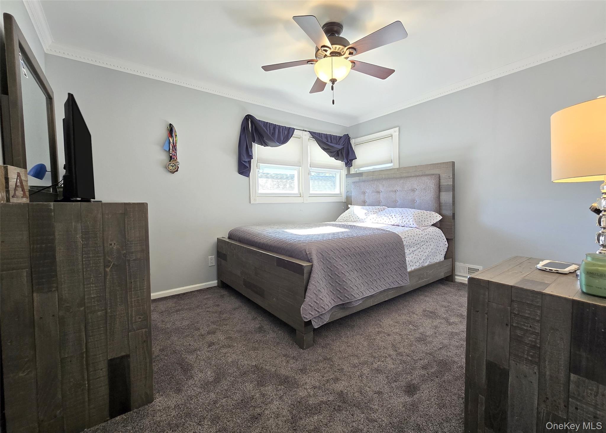 6 Virginia Road Centereach, NY 11720 - Photo 14 of 23 a bedroom with a bed and a chandelier