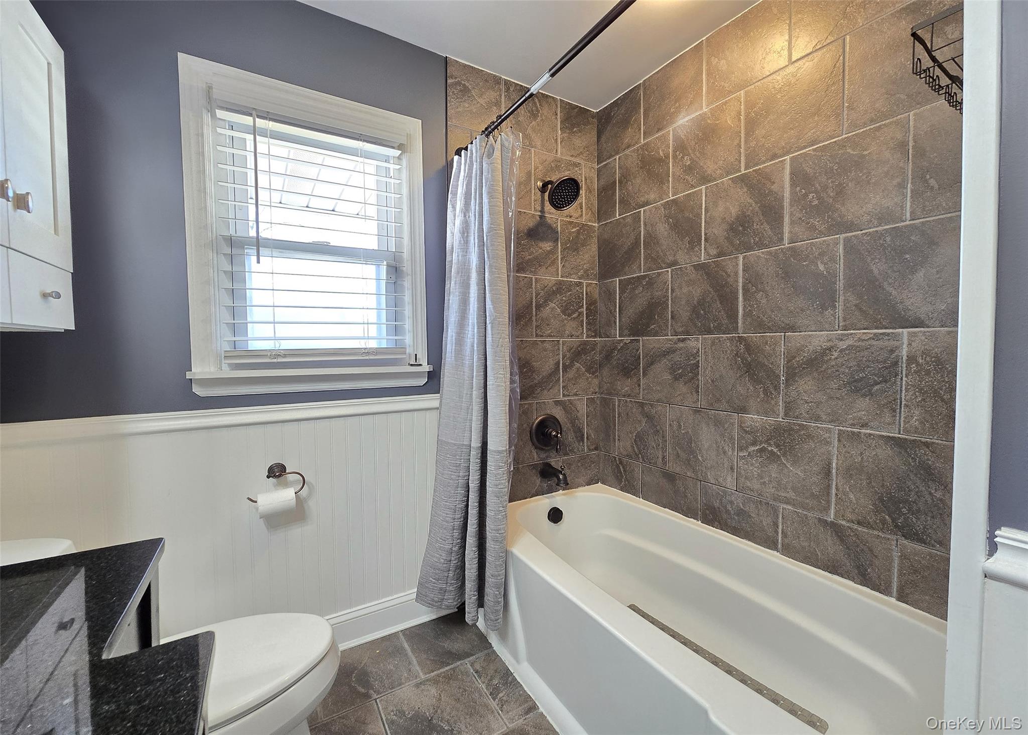 6 Virginia Road Centereach, NY 11720 - Photo 16 of 23 a bathroom with a bathtub a window and a shower