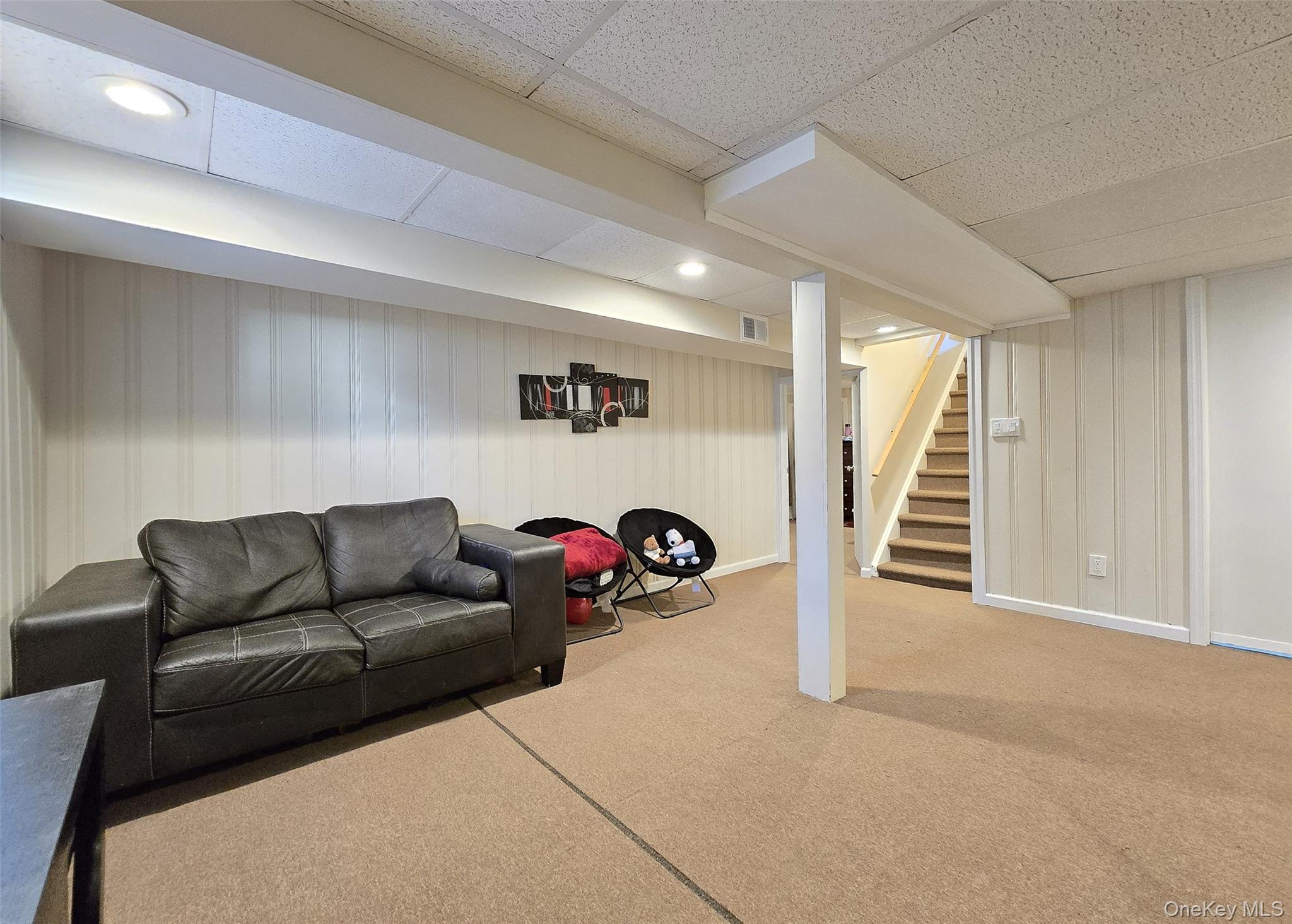 6 Virginia Road Centereach, NY 11720 - Photo 19 of 23 a living room with furniture and a flat screen tv