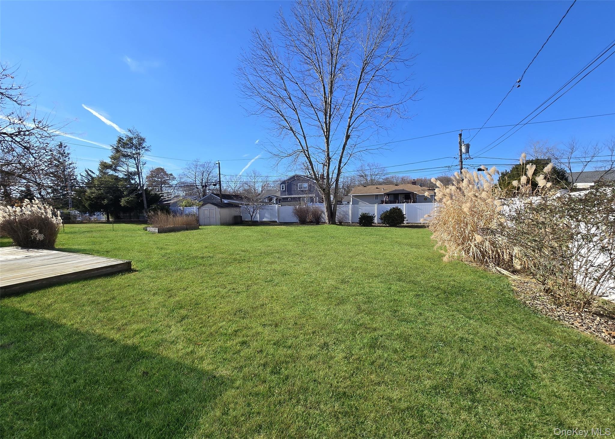 6 Virginia Road Centereach, NY 11720 - Photo 21 of 23 a view of a yard with a house in the background